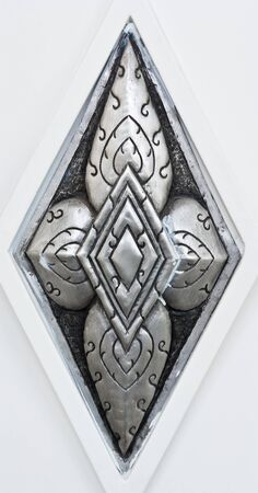Silver carvings in Thai style on the white wall の写真素材
