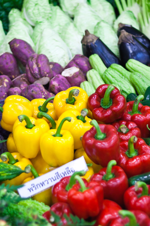 Ripe Yellow, Red and Green Peppers in Vegetables Marketの写真素材