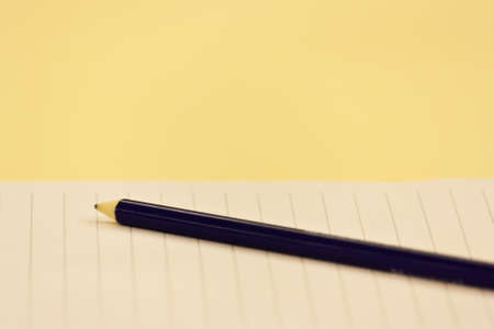 Blue pencil on blank white paper with lineの写真素材