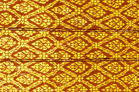 Thai art gold painting pattern on door Wat Thai in Thailandの写真素材