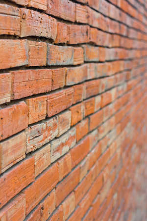 The perspective of a red brick wall focuses on  1 part 3 in front.の写真素材