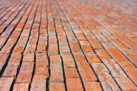 The perspective of a red brick walk focuses on  1 part 3 in front.の写真素材