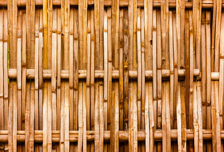 old grungy thai handcraft of bamboo weave pattern fenceの写真素材