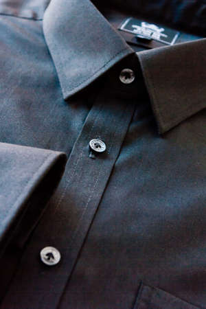 Dark men's shirts show the collar, cuffs, placket, buttons, and parts of the pocket.の写真素材