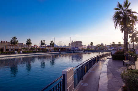 DUBAI, UAE - DEC-16 2020 Beautiful view of the country pavilions ,and Canal with pleasure boats in...
