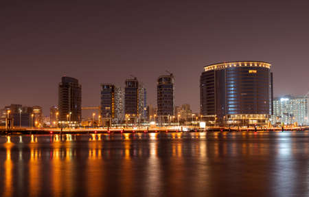 Jan 21st, 2021. Dubai,UAE. View of the beautifully illuminated Jewel of the creek buildings with the floating bridge, captured from the creek park, Dubai,UAE.のeditorial素材