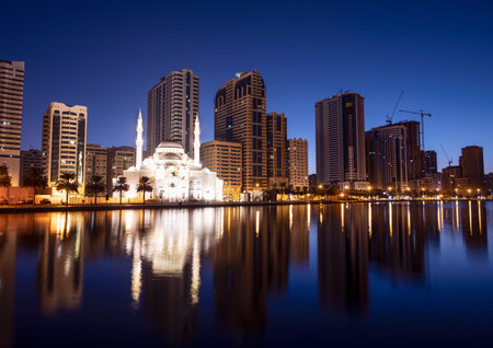 Dec 17 2020, Al seef village, Dubai. Panoramic view of the illuminated sky scrappers,hotels and buildings showing beautiful reflections in water captured at the Al Seef, Dubai ,UAE.のeditorial素材