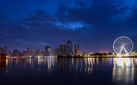 Dec 17 2020, Al seef village, Dubai. Panoramic view of the illuminated sky scrappers,hotels and buildings showing beautiful reflections in water captured at the Al Seef, Dubai ,UAE.のeditorial素材