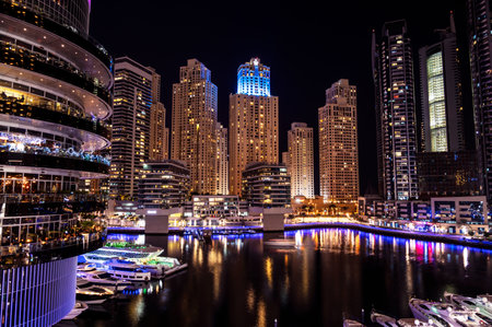 Dec 17 2020, Al seef village, Dubai. Panoramic view of the illuminated sky scrappers,hotels and buildings showing beautiful reflections in water captured at the Al Seef, Dubai ,UAE.のeditorial素材