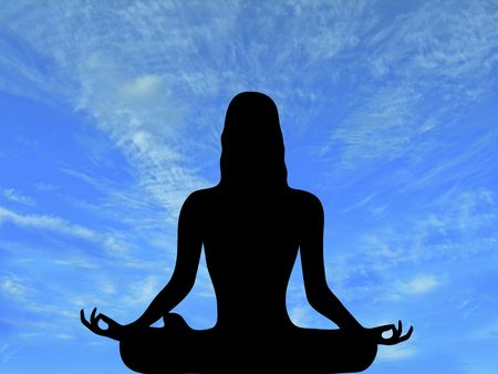 silhouette of woman meditating with brilliant blue sky backgroundの写真素材