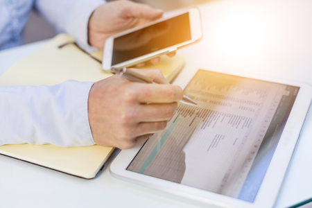 Accounting on a tablet computer, close-upの写真素材