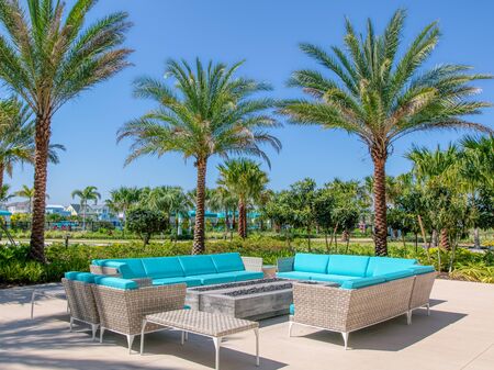 Margaritaville Resort Orlando. Aqua couches under palm trees mark a lounge area for outside seating at hotel.のeditorial素材