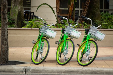 ORLANDO, FLORIDA - JULY 13, 2019: Green Lime bike share rentals parked on a downtown street.のeditorial素材