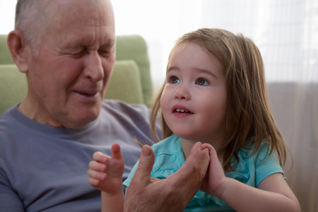 Cute little girl holding her grandfather\\の写真素材