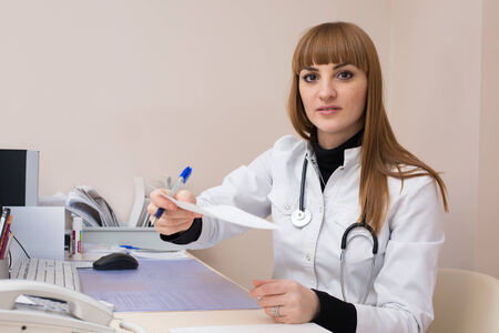 Female doctor handing off medical recommendationsの写真素材