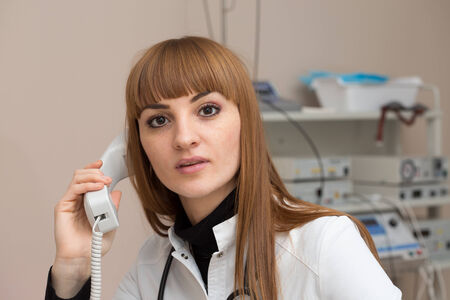 Female doctor talking on the phoneの写真素材