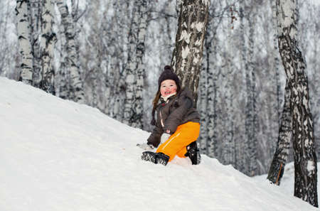 A little girl climbing up on a hillの写真素材