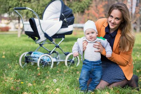 A mother playing with her little son in a parkの写真素材