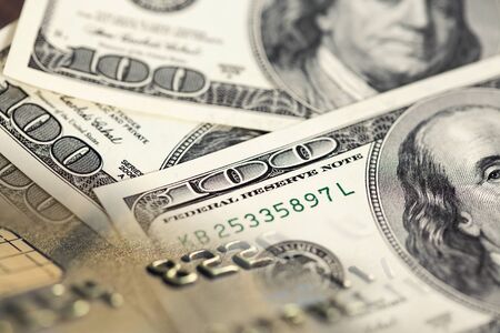 Collage with one hundred US dollar bills and credit cardの写真素材