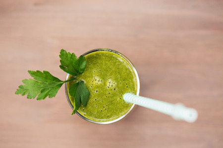 A green smoothie with parsley in a glassの写真素材