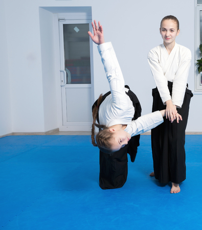 Two girls in black hakama practice Aikido on martial arts trainingの写真素材