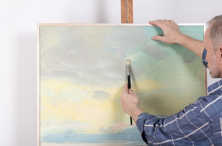 An artist painting in studio. Selective focusの写真素材