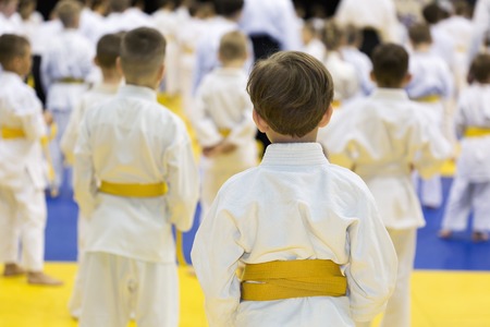 Children in kimono sitting on tatami on martial arts seminar. Selective focus on a boyの写真素材