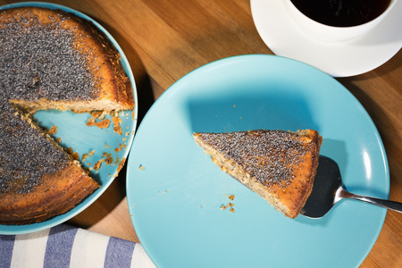 A piece of a lemon cake served with a cup of coffeeの写真素材