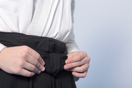 Hands of a teenager tie a hakamaの写真素材