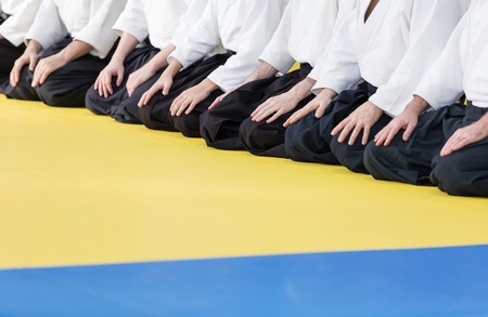 People in kimono and hakama sitting in a long line on martial arts training seminar. Selective focusの写真素材