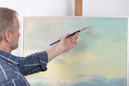 An artist painting in studioの写真素材