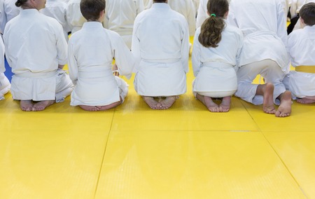 People in kimono sitting in a long line on tatamiの写真素材