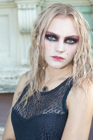A fashion gothic style portrait of a beautiful blonde girl