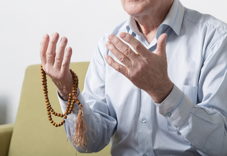 Praying hands of an old manの写真素材
