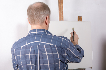 An artist in studio white canvasの写真素材