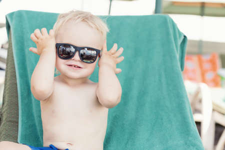 Blond toddler boy wearing sunglassesの写真素材