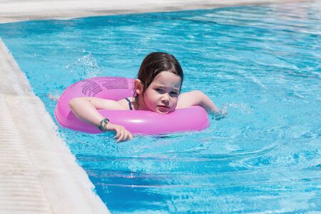 Little girl swimming in a poolの写真素材