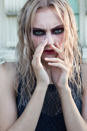 A fashion gothic style portrait of a beautiful blonde girlの写真素材