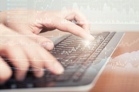 Female typing on laptop computer keyboardの写真素材