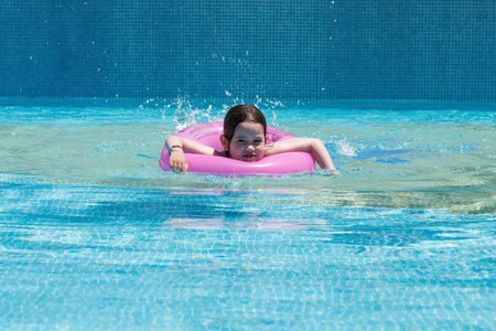 Little girl swimming in a poolの写真素材