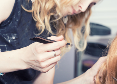 A hairdresser making a haircutの写真素材