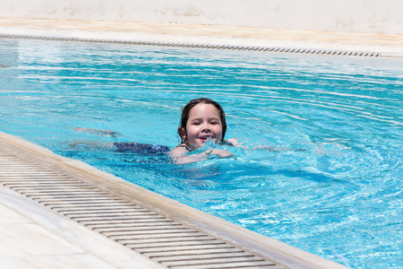 Little girl swimming in a poolの写真素材