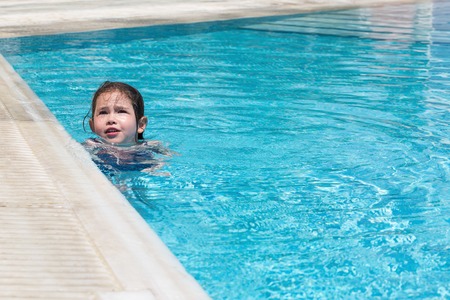 Little girl swimming in a poolの写真素材