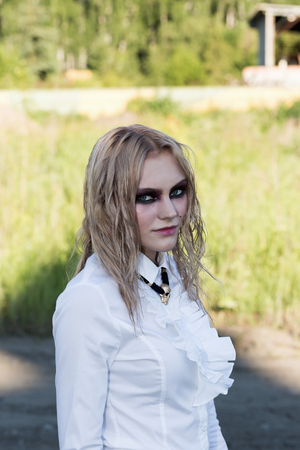 A fashion gothic style portrait of a beautiful blonde girlの写真素材