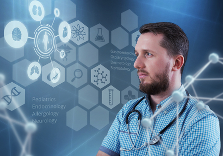 Handsome male doctor and virtual computer interfaceの写真素材