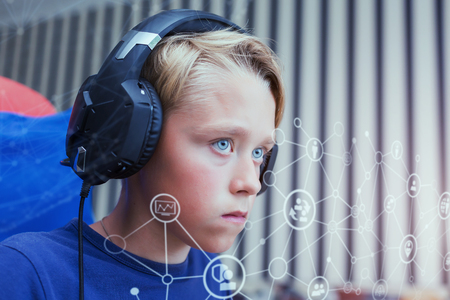 Teenage blond boy playing computer games on PC. Global networkの写真素材