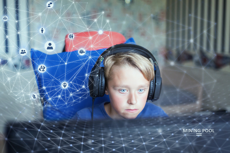 Teenage boy playing computer games on PCの写真素材