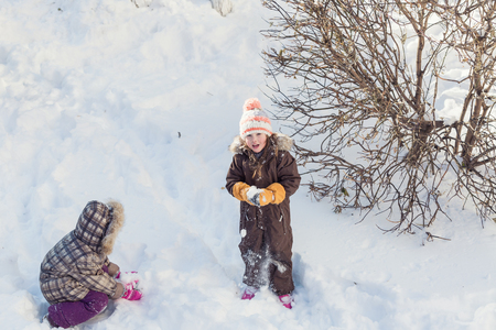 Children playing in a snowの写真素材