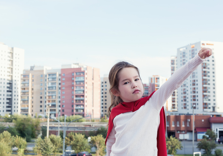 Superhero kid against urban backgroundの写真素材