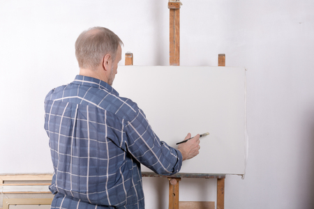 An artist in studio white canvasの写真素材